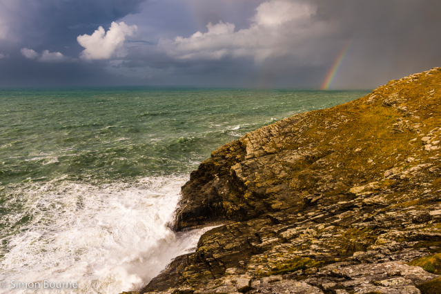 Simon Bourne, photography, photographer, Tintagel, Cornwall, portfolio, image, winter, afternoon, Penhallic Point, cove, storm, surf, waves, sea, cliffs, rainbow